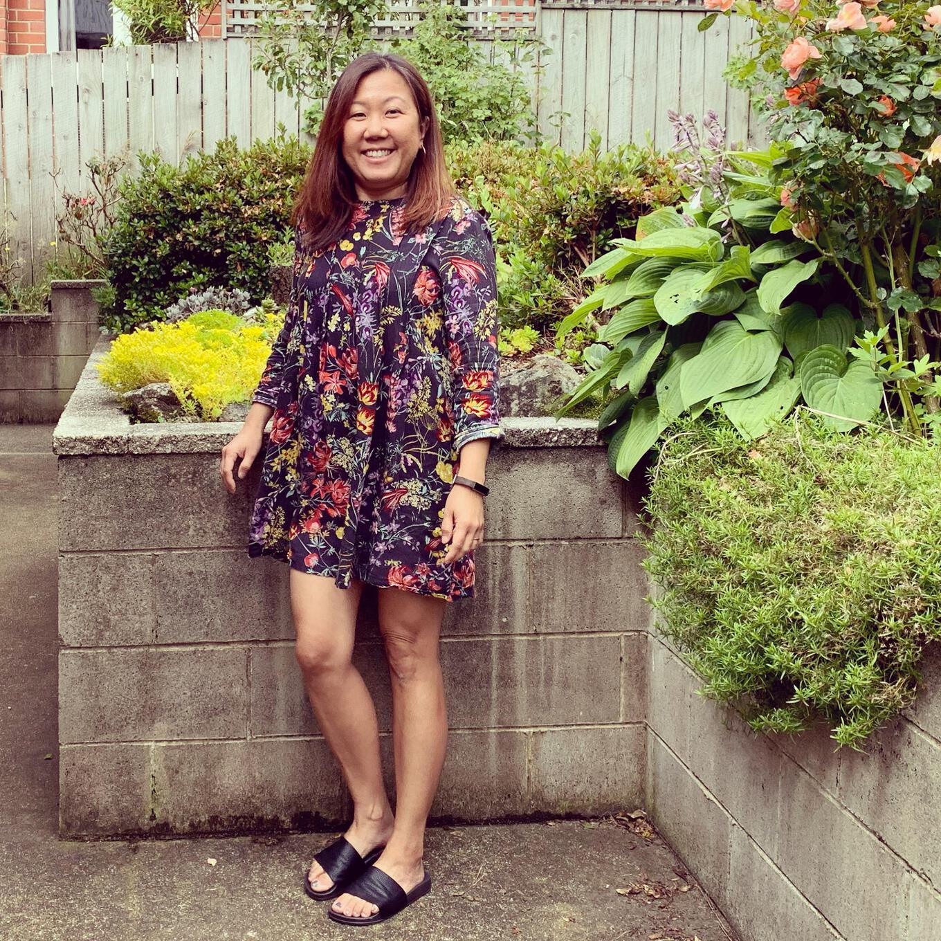 Who knew you could look this good only spending $18? A picture of Dora in her thrifted outfit - a $10 H&M dress and $8 new slides